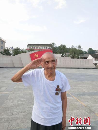 圖爲:楊成餘在三門亭旁初心廣場敬禮 李貝妮 攝