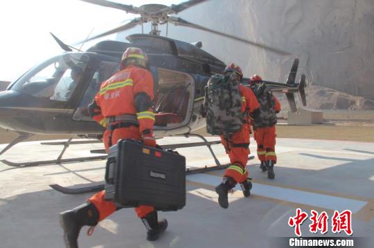 冬訓期間,甘肅白銀消防支隊與甘肅平貴通用航空有限公司進行“空地聯動”應急救援消防演練。圖爲消防員乘坐飛機到救援現場。 張傑 攝